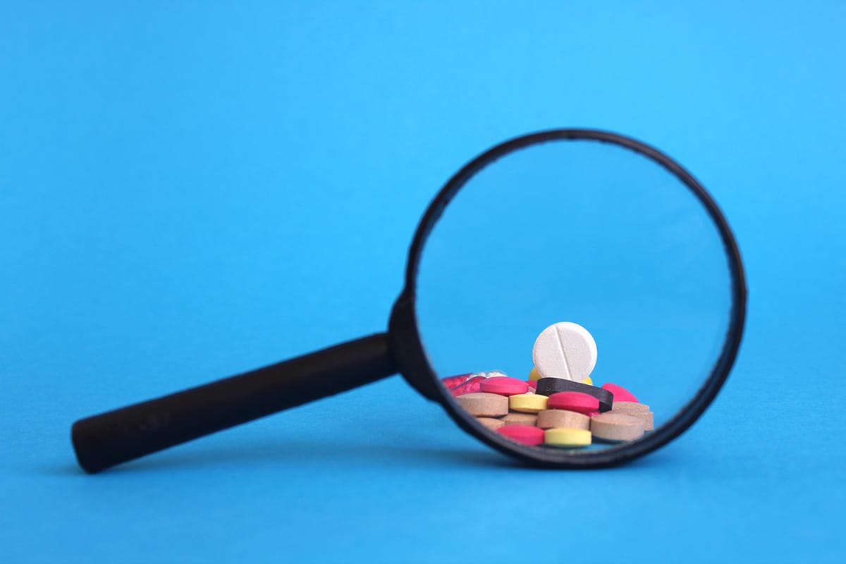 Different Pills Are Visible Through A Magnifying Glass